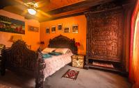 a bedroom with a large wooden bed in a room at la maison d&#39;idylle in Combourg