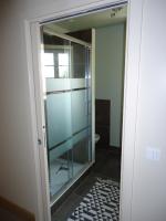 a glass door to a bathroom with a shower at La Maison des tilleuls in Entrains-sur-Nohain