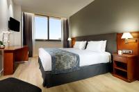 A bed or beds in a room at Exe Isla Cartuja