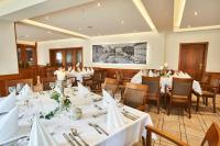 a dining room with white tables and chairs at Das Landhotel am Trätzhof Fulda in Fulda