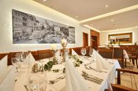 a dining room with a table with white table cloth at Das Landhotel am Trätzhof Fulda in Fulda