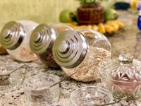 a table topped with glass jars and bowls of food at Hotel Olivier in Três Rios