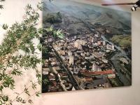 a painting of a city hanging on a wall at Hotel Olivier in Três Rios