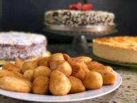 a plate of food on a table with cakes and pies at Hotel Olivier in Três Rios
