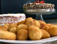 a plate of food with two cakes on a table at Hotel Olivier in Três Rios