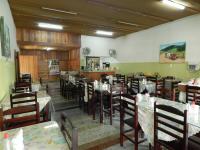 a dining room with tables and chairs in a restaurant at Hotel Olivier in Três Rios