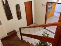 a hallway with stairs and a door in a building at Hotel Olivier in Três Rios
