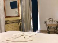 a pair of white towels sitting on top of a bed at Hotel Olivier in Três Rios