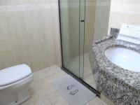 a bathroom with a sink and a toilet at Hotel Olivier in Três Rios