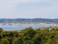 a view of a city and a body of water at PLEIADES lUXURY APARTMENTS in Porto Heli
