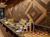 a buffet line in a restaurant with food on it at Zayn Hotel Bangkok - Airport Link Access in Bangkok