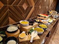 a buffet line with many different types of food at Zayn Hotel Bangkok - Airport Link Access in Bangkok