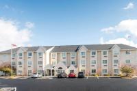 a large building with cars parked in a parking lot at Microtel Inn and Suites North Canton in North Canton
