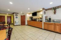 a restaurant with a bar and a kitchen with a counter at Microtel Inn & Suites by Wyndham Auburn in Auburn