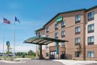 a hotel with an american flag in front of it at Wingate by Wyndham Sidney in Sidney
