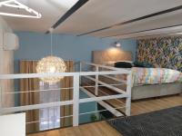 A bed or beds in a room at Tempo Life Apartman