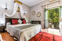 a bedroom with a large bed and a balcony at Hacienda el Santiscal in Arcos de la Frontera