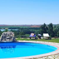 a dog laying on a chair next to a swimming pool at Hacienda el Santiscal in Arcos de la Frontera