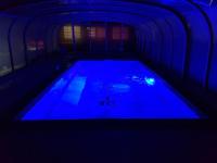 a swimming pool in a dark room with blue lighting at Chambre d&#39;hôtes source de la St Baume in Plan dʼAups