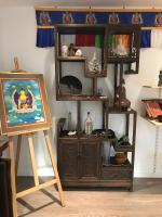 a painting on a easel in a room with a shelf at La Bichurie in Feugères