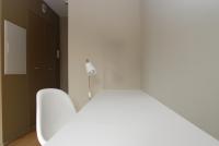 a white room with a white table and a lamp at Temporesidence Cathedrale in Bayonne