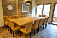 a dining room with a wooden table and chairs at Camping Bissen in Esch-sur-Sûre