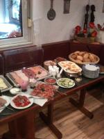 a table with many different types of food on it at Pension Zum Lindeneck in Lübz