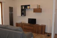 Televízia a/alebo spoločenská miestnosť v ubytovaní Vittori Apartment
