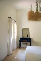 a bedroom with a bed and a mirror and a table at Serendip in Avignon