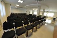 an empty room with black chairs in a building at Klein Ville São Leopoldo in São Leopoldo