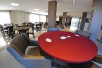 a red table in a restaurant with chairs and tables at Klein Ville São Leopoldo in São Leopoldo