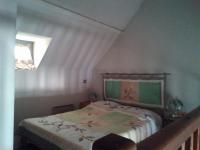 a bedroom with a bed in a attic with a window at les goutilles in Sainte-Marie-de-Campan