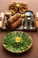 a table with a plate of food on a table at HARRIS Hotel Batam Center in Batam Center