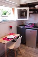 a small kitchen with a table and a sink at Capitole - Studio d&#39;amoureux sur les toits in Toulouse