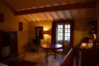 a room with a table and chairs and a window at Gites Le Clos de Saires in Saires