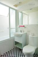 a white bathroom with a toilet and a sink at Lio Hotel - Taipei Main Station in Taipei