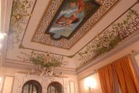 a room with a ceiling with paintings on it at Hotel Gresi in Catania