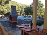 a table with wine glasses and a fireplace on a patio at Dee&#39;s House and Pool in Labin
