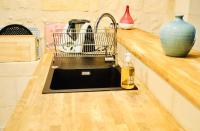 a kitchen sink with a dish drying rack next to it at Esprit Bordelais in Bordeaux