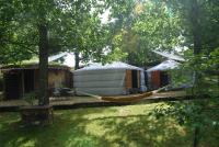 a hammock in a yard next to a yurt at Yourtes de Gascogne in Lannes