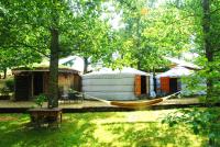 a hammock in a yard next to a yurt at Yourtes de Gascogne in Lannes