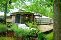 a gazebo with a chair in a garden at Yourtes de Gascogne in Lannes