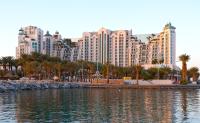a view of a large city with palm trees and buildings at Herods Palace Hotels & Spa Eilat a Premium collection by Fattal Hotels in Eilat