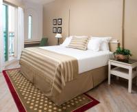 a bedroom with a large bed and a table at Herods Palace Hotels & Spa Eilat a Premium collection by Fattal Hotels in Eilat