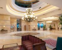 a lobby with a couch and a chandelier at Herods Palace Hotels & Spa Eilat a Premium collection by Fattal Hotels in Eilat