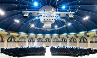 a chandelier hangs from the ceiling of a large auditorium at Herods Palace Hotels & Spa Eilat a Premium collection by Fattal Hotels in Eilat