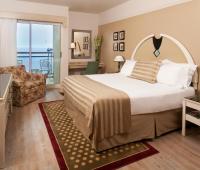 a bedroom with a large bed and a balcony at Herods Palace Hotels & Spa Eilat a Premium collection by Fattal Hotels in Eilat