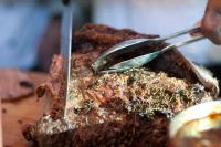 a person holding a spoon and a piece of meat at Herods Palace Hotels & Spa Eilat a Premium collection by Fattal Hotels in Eilat