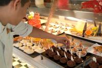 a chef is preparing cupcakes in a buffet at Herods Palace Hotels & Spa Eilat a Premium collection by Fattal Hotels in Eilat