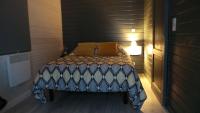 a small bedroom with a bed in a room at Au Cap Norwoe in Saint-Quentin-en-Tourmont